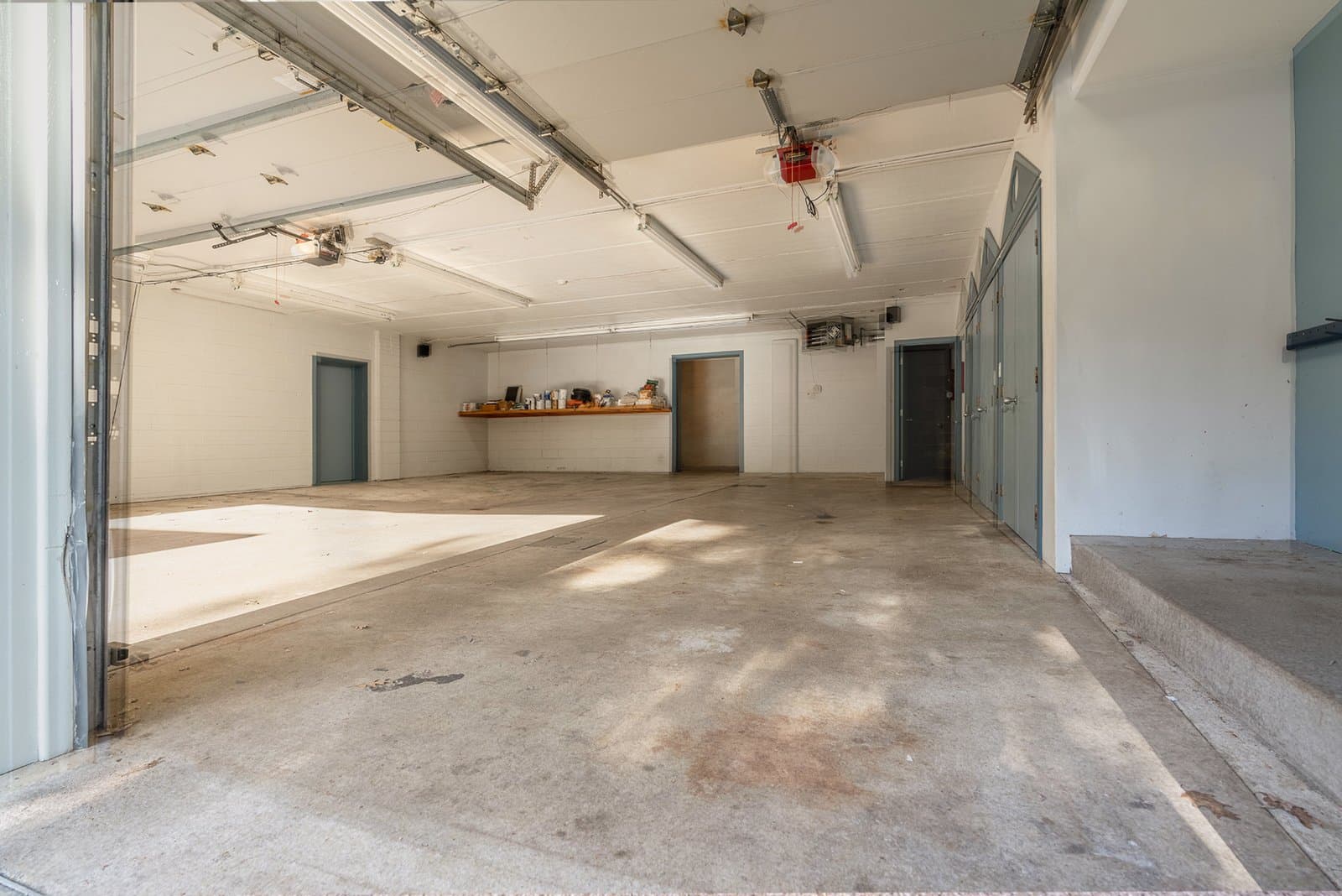 Bare, stained concrete garage floor before the Penntek coating