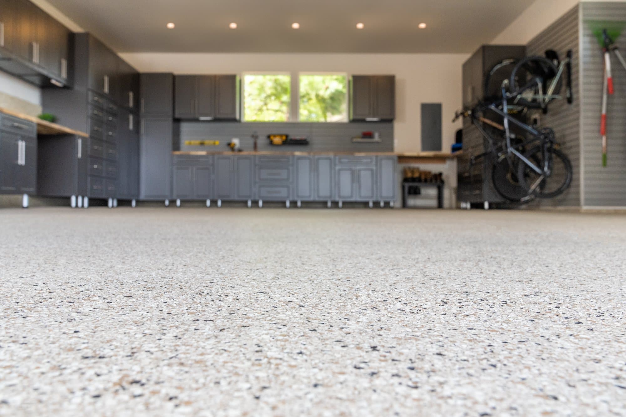 Residential garage with a glossy flake-coated floor and built-in cabinets